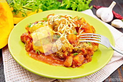 Image of Porridge corn with meat and vegetables in plate on towel