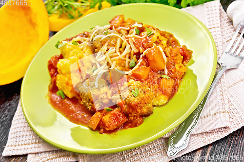 Image of Porridge corn with meat and vegetables in plate on wooden board