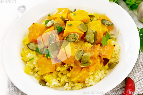 Image of Porridge millet with spicy pumpkin in plate on board