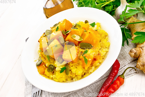 Image of Porridge millet with spicy pumpkin in plate on table