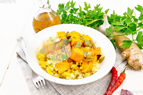 Image of Porridge millet with spicy pumpkin in plate on towel