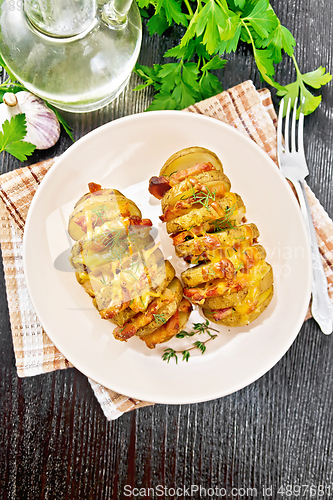 Image of Potatoes with smoked bacon in plate on board top