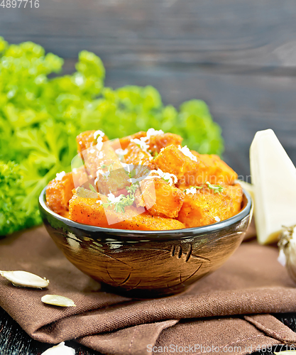 Image of Pumpkin fried with spices in bowl on towel