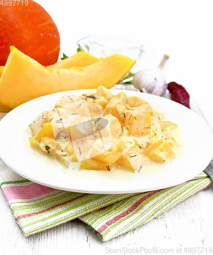 Image of Pumpkin with sour cream sauce in plate on table