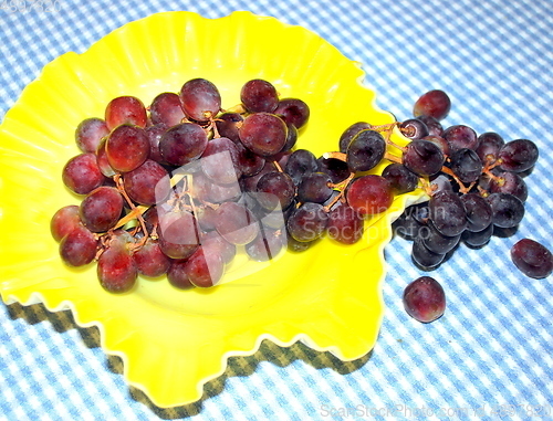 Image of Red grapes on a table.