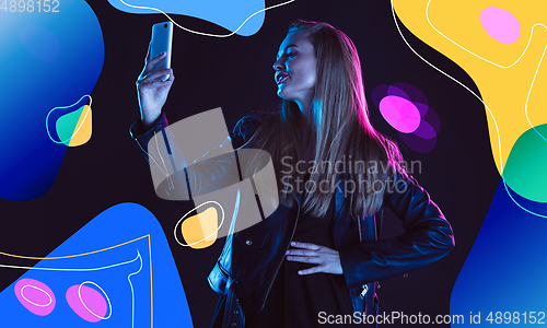 Image of Caucasian woman\'s portrait in neon light on modern illustrated background.