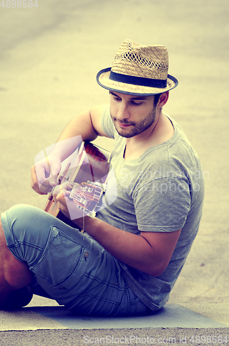 Image of Man plays the guitar