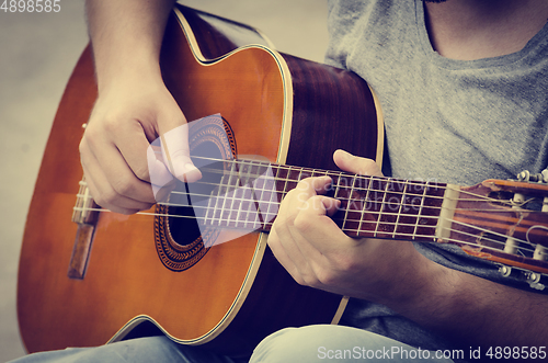 Image of Man plays the guitar