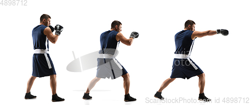 Image of Young boxer against white studio background in motion of step-to-step kicking