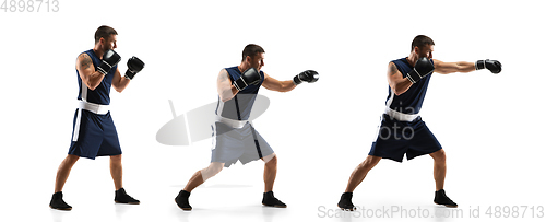 Image of Young boxer against white studio background in motion of step-to-step kicking