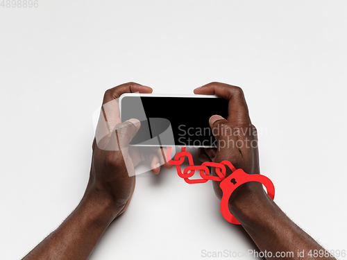 Image of Hand using laptop, device on top view. Addicted, wired with chain to social media on the screen