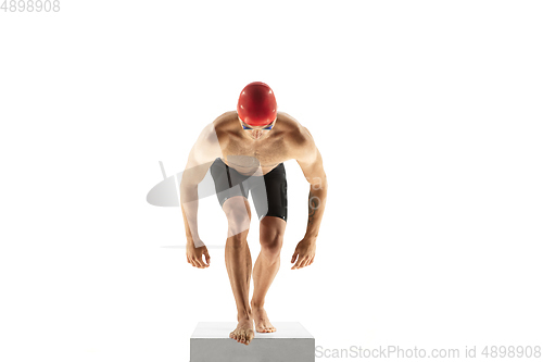 Image of Caucasian professional sportsman, swimmer training isolated on white studio background