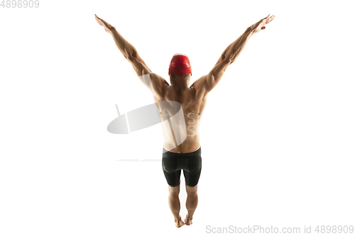 Image of Caucasian professional sportsman, swimmer training isolated on white studio background