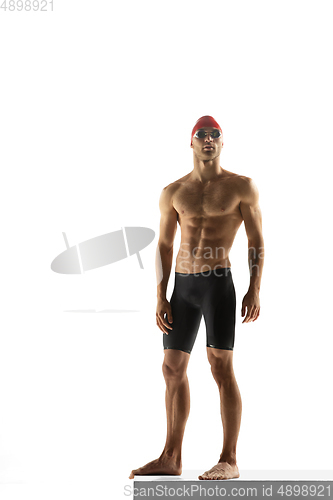 Image of Caucasian professional sportsman, swimmer training isolated on white studio background