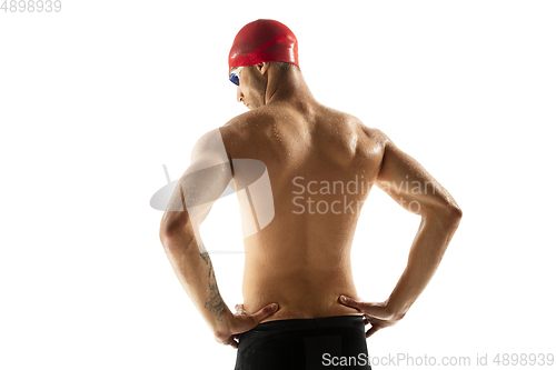 Image of Caucasian professional sportsman, swimmer training isolated on white studio background