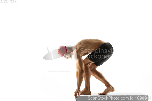 Image of Caucasian professional sportsman, swimmer training isolated on white studio background