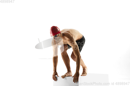 Image of Caucasian professional sportsman, swimmer training isolated on white studio background