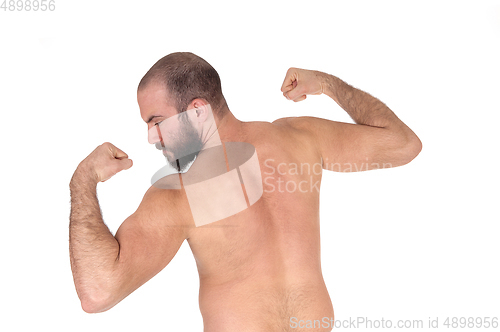 Image of Man standing from back shirtless showing his muscles