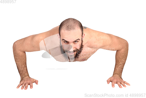 Image of Man with beard doing push ups on the floor