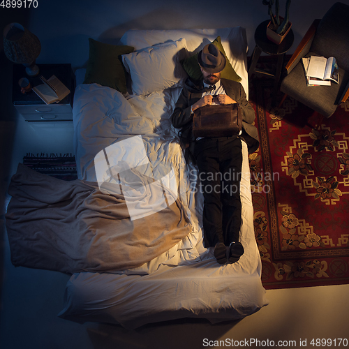 Image of Portrait of a businessman, accountant sleeping in the bed at home