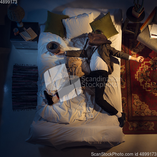 Image of Portrait of a businessman, accountant sleeping in the bed at home