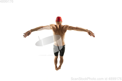 Image of Caucasian professional sportsman, swimmer training isolated on white studio background