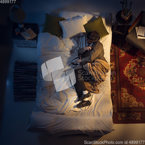 Image of Portrait of a businessman, accountant sleeping in the bed at home