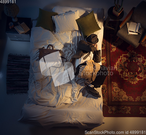 Image of Portrait of a businessman, accountant sleeping in the bed at home