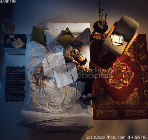 Image of Portrait of a businessman, accountant sleeping in the bed at home