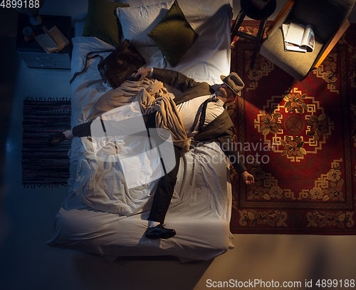 Image of Portrait of a businessman, accountant sleeping in the bed at home