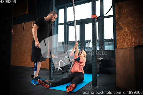 Image of Disabled woman training in the gym of rehabilitation center