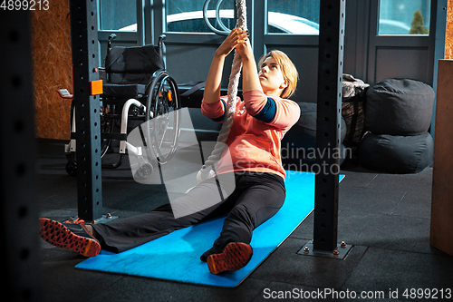 Image of Disabled woman training in the gym of rehabilitation center