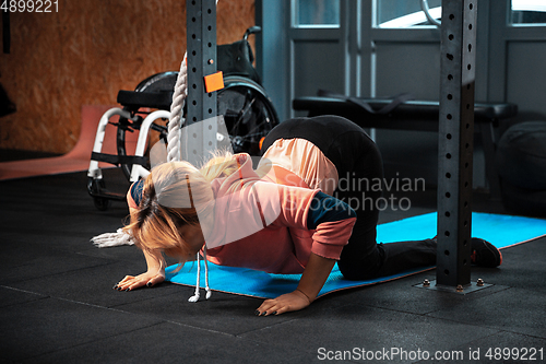 Image of Disabled woman training in the gym of rehabilitation center