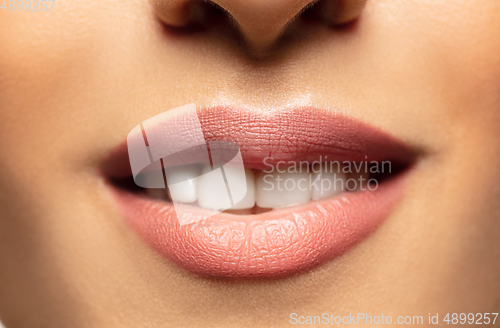 Image of Close-up shoot of beautiful female lips with natural lipstick make up