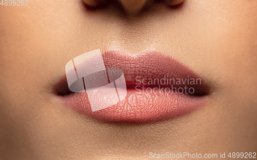 Image of Close-up shoot of beautiful female lips with natural lipstick make up