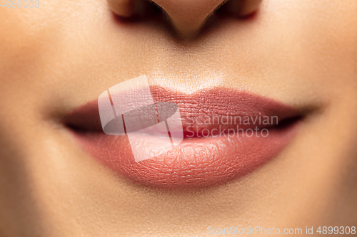 Image of Close-up shoot of beautiful female lips with natural lipstick make up