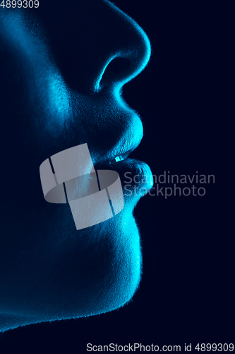 Image of Portrait of beautiful albino girl isolated on dark studio background in neon light