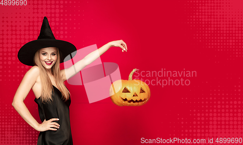 Image of Young woman a witch on scary background