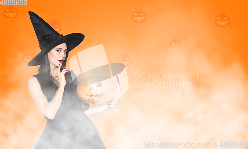 Image of Young woman a witch on scary background