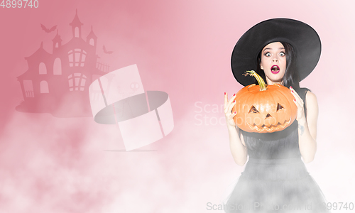 Image of Young woman a witch on scary background