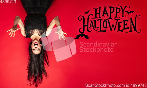 Image of Young woman a witch on scary background