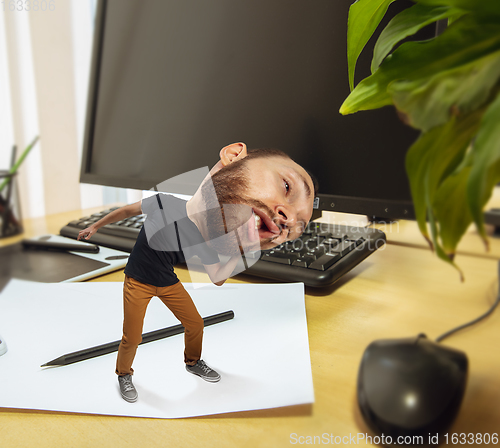 Image of Tired man, office worker holding his huge tired head, funny