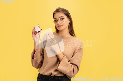 Image of Portrait of young caucasian woman with bright emotions isolated on yellow studio background