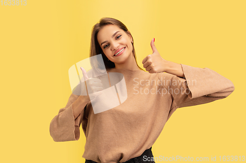 Image of Portrait of young caucasian woman with bright emotions isolated on yellow studio background