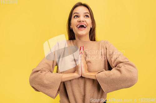 Image of Portrait of young caucasian woman with bright emotions isolated on yellow studio background