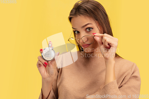 Image of Portrait of young caucasian woman with bright emotions isolated on yellow studio background