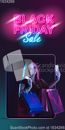 Image of Beautiful woman inviting for shopping right from device screen, black friday, sales concept. Flyer with copyspace