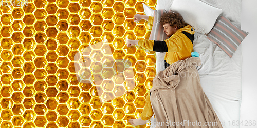 Image of Portrait of a young man sleeping and dreaming about honey