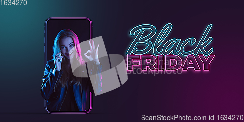 Image of Beautiful woman inviting for shopping right from device screen, black friday, sales concept. Flyer with copyspace