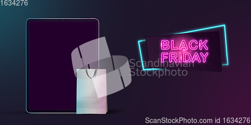 Image of Device with shopping bags, black friday, sales concept. Flyer with copyspace. Dark neoned background